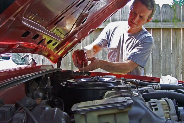 man performing oil change at home