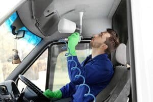 Mechanic repairing the car headliner